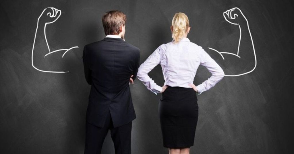 Well dressed male and female office workers stand inbetween two strong arms signifying empowered employees