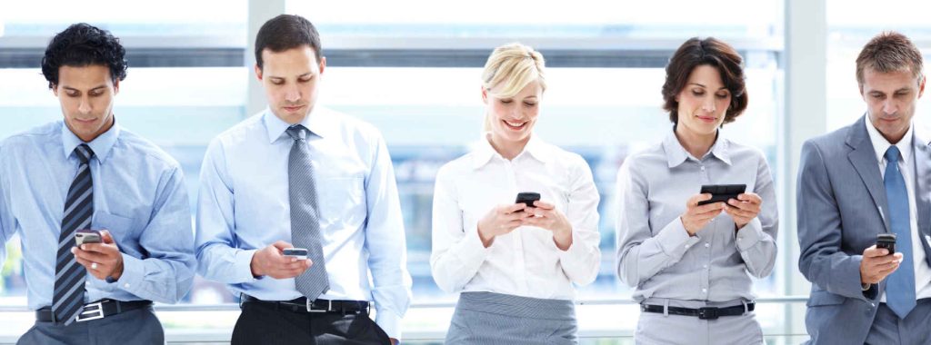 Group of happy company employees use their business mobile phone plan for communication