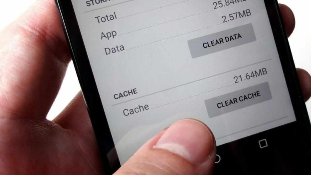 Person clears the cache of their iPhone to speed up a slow mobile phone