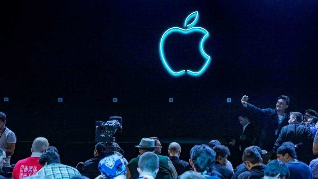 Crowd of fans await the start of Apple conference at WWDC event