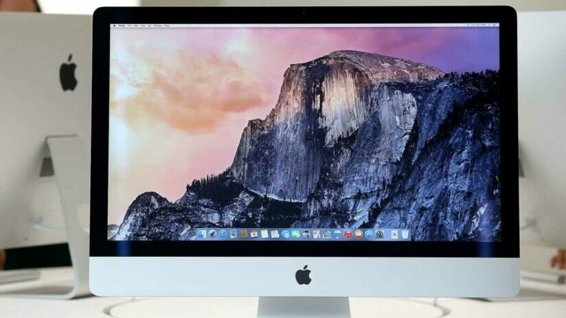 Lifestyle shot of unlocked Apple iMac on desk with keyboard and mouse