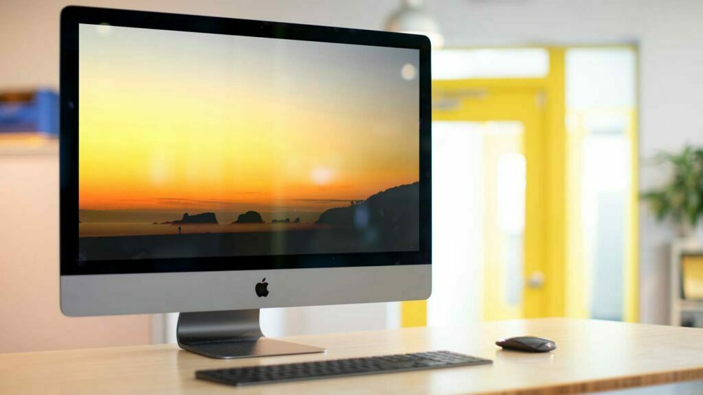 iMac Pro 2021 all in one home computer sitting on desk with mouse and keyboard