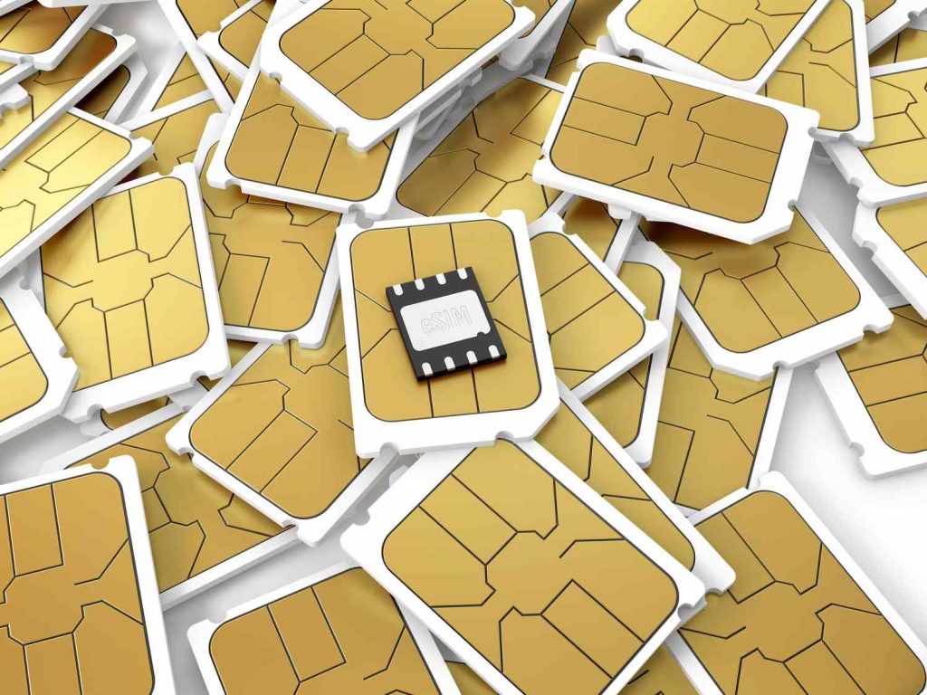 eSIM lies on pile of full-size business SIM cards