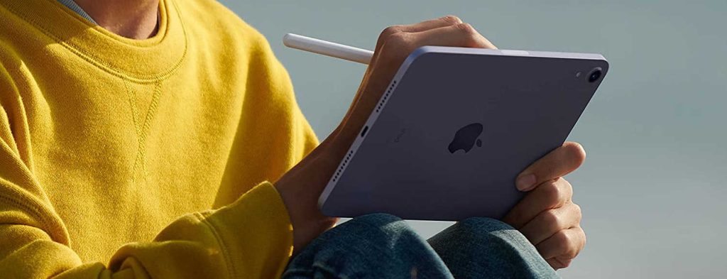 Person sitting outside uses stylus with Apple iPad Air