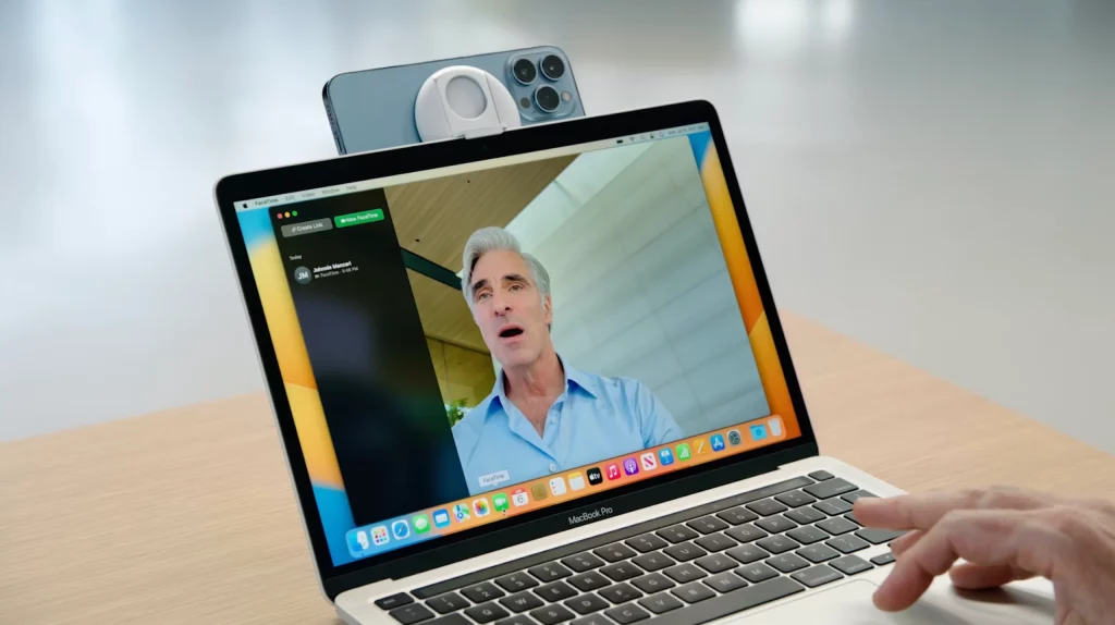 Employee in virtual conference call uses iPhone 14 iOS 16 feature as a webcam for their MacBook