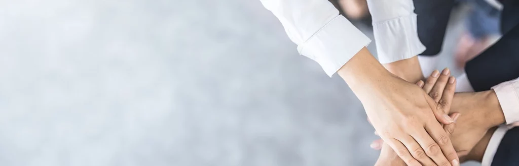 Group of business employees supporting eachother in a group handshake