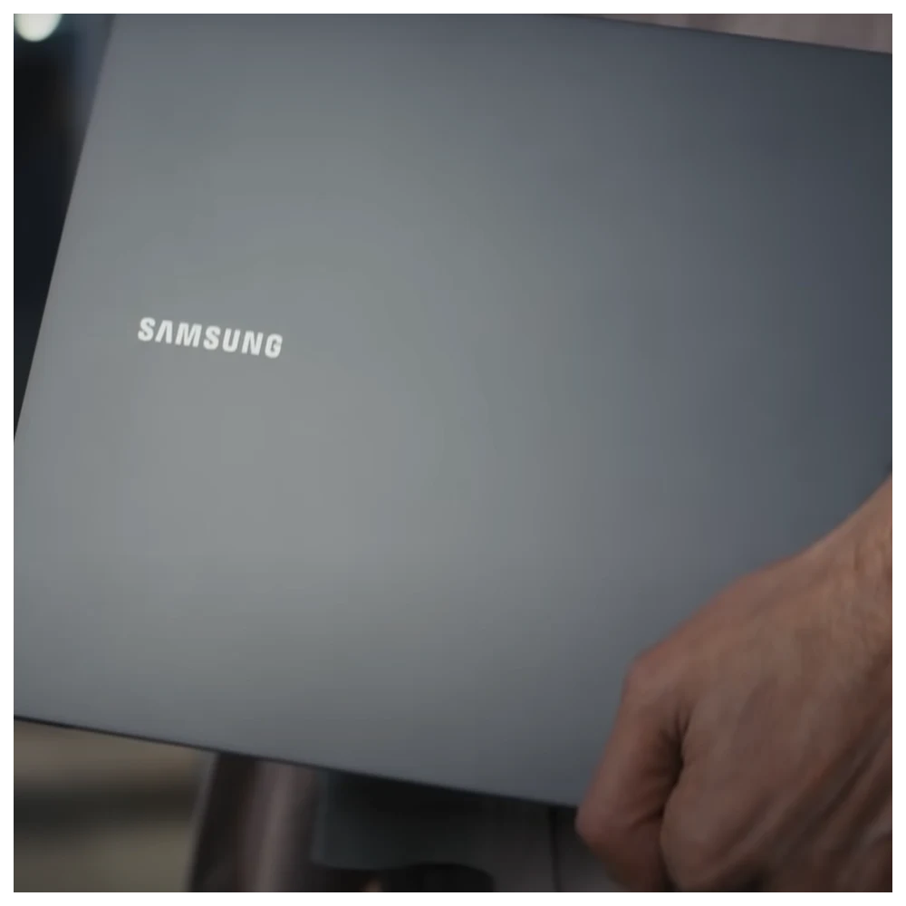 Close up shot of person taking Galaxy Book2 Series to work