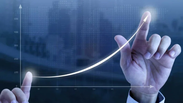 Hand charts out business growth graph